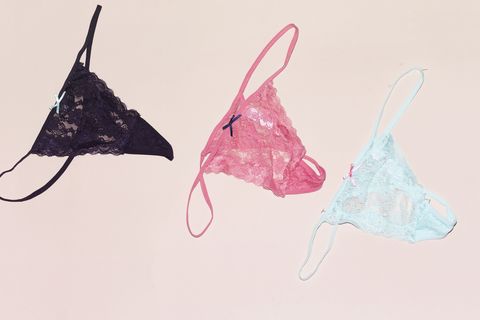 three differents Colors of string lace panties isolated on pink background