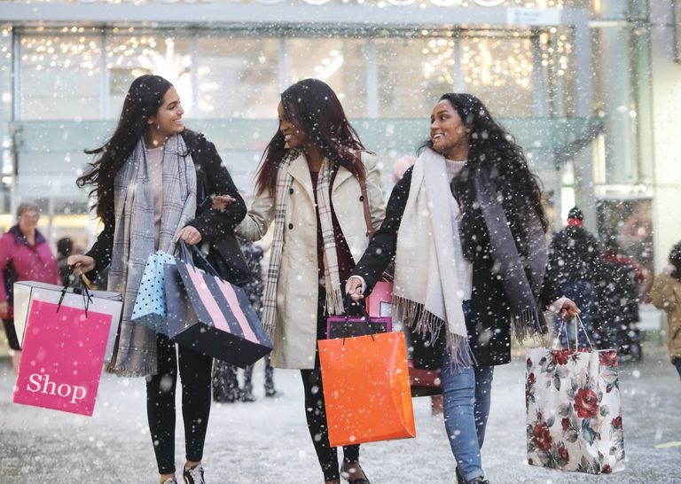 three-young-women-in-town-shopping-in-th