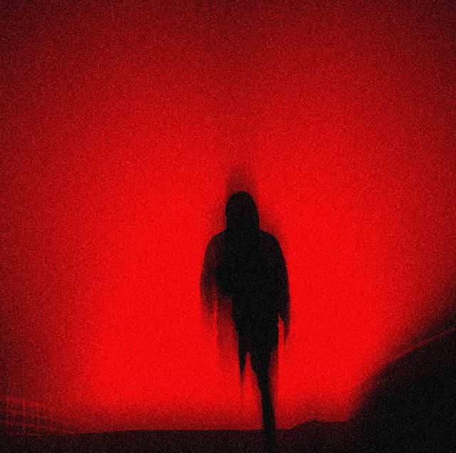 red outline of an ominous black figure with faded edges