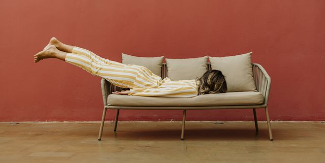 tired young woman sleeping on sofa
