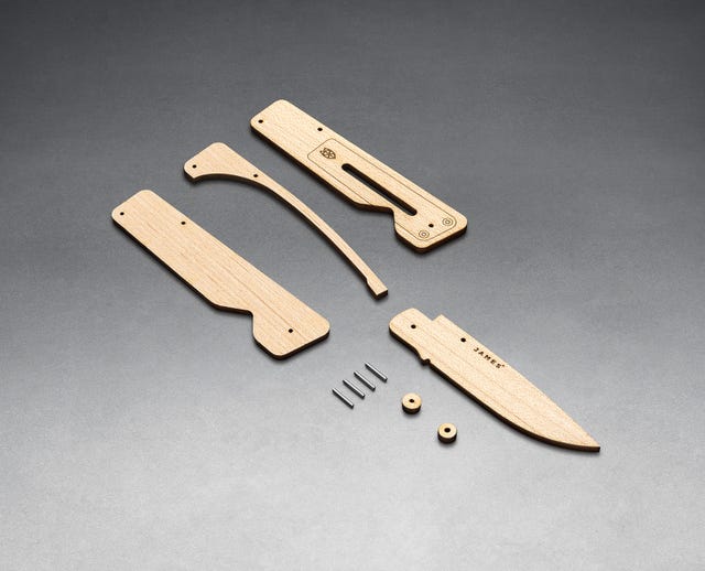 wooden knife taken apart and laid out on a metallic surface