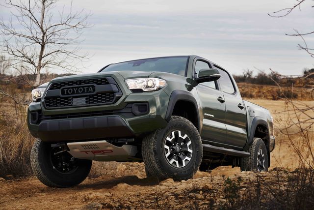 toyota tacoma perched on a rocky trail