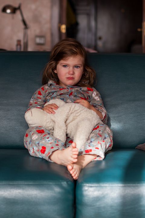 Toddler girl on couch in living room