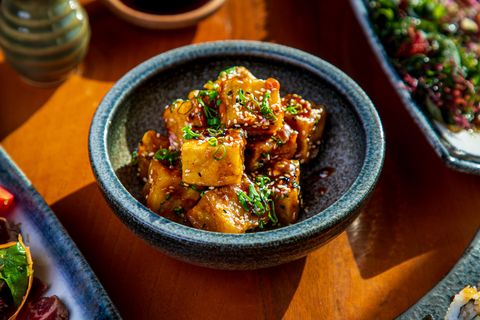 tofu cubes fried and served with black and white sesame in a bowl