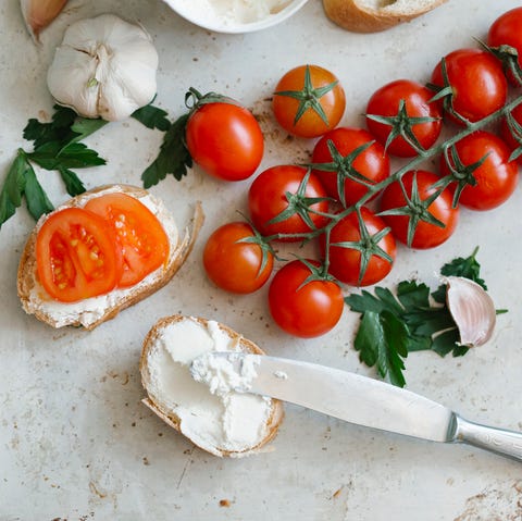 Tomatoes on vine near cream cheese and bread tomatoes on vine near cream cheese and bread