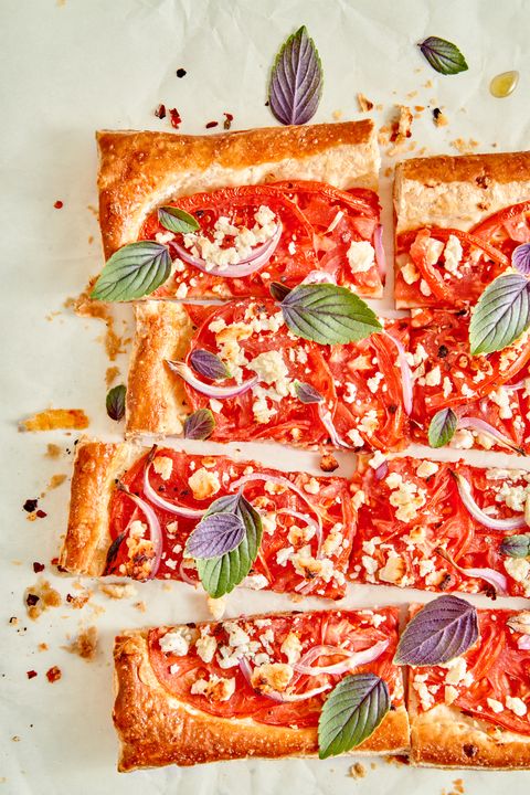 tomato tart cut into slices and garnished with purple basil