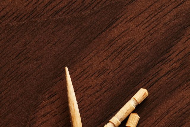 three toothpicks on wooden table