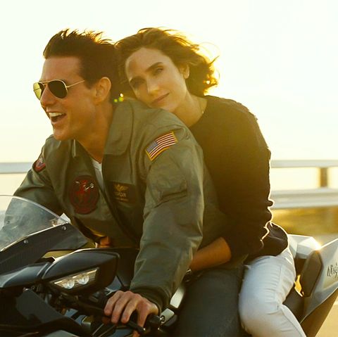 Maverick and Penny go for a motorcycle ride in a scene from Top Gun Maverick