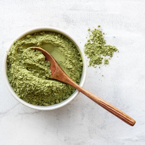 healthy matcha tea powder in a bowl with a spoon