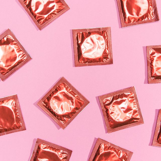 Top view condoms red wrappers,Directly above shot of pink desserts on pink background