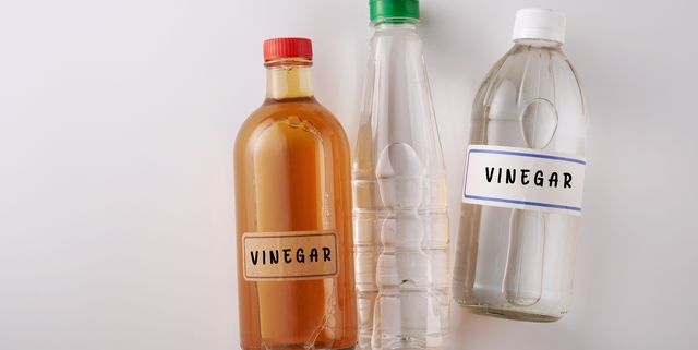 top view two bottles white vinegar and  bottle of apple cider vinegar