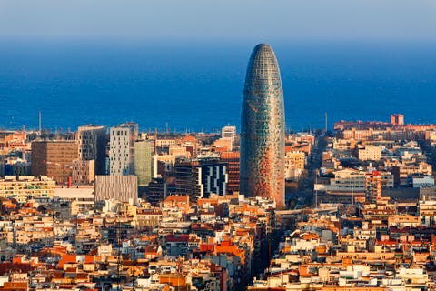 torre agbar with the mediterranean in the background, barcelona, spain
