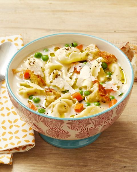 creamy tortellini soup in red and white bowl