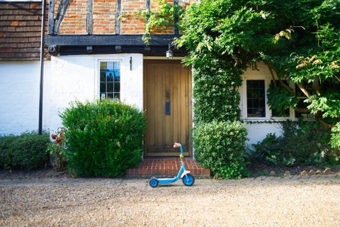 Toy scooter parked outside cottage