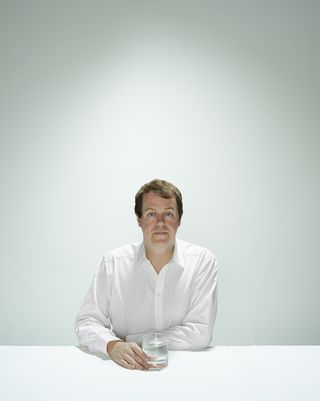 tom parker bowles in a white shirt sitting at a table
