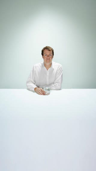 tom parker bowles in a white shirt sitting at a table