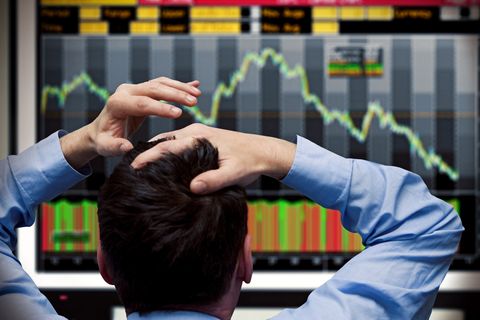 trader watching stocks crash on screen