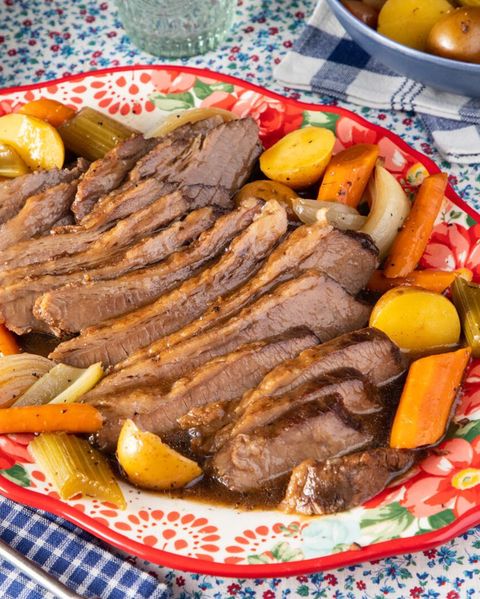 traditional passover food dishes slow cooker brisket on platter with carrots and potatoes