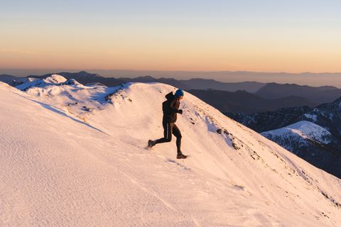 Trail runner makes his way down snowy hill