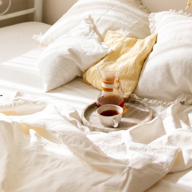 tray with chemex coffee and mug on white linen bedding in the bedroom
