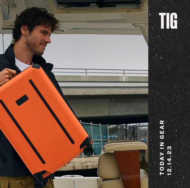 today in gear december 14 2023 a man holding a orange ridge carry on suitcase