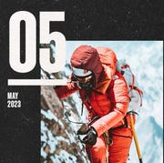 a woman rock climbing a snowy cliff