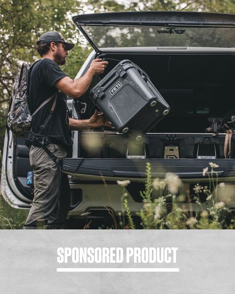 sponsored product academy sports man hoisting yeti cooler with one hand into the back of his car