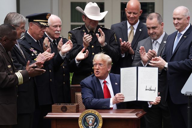 washington, dc   june 16  surrounded by members of law enforcement, us president donald trump holds up an executive order he signed on ‚Äúsafe policing for safe communities‚Äù during an event in the rose garden at the white house june 16, 2020 in washington, dc president trump signed an executive order on police reform amid the growing calls after the death of george floyd photo by alex wonggetty images
