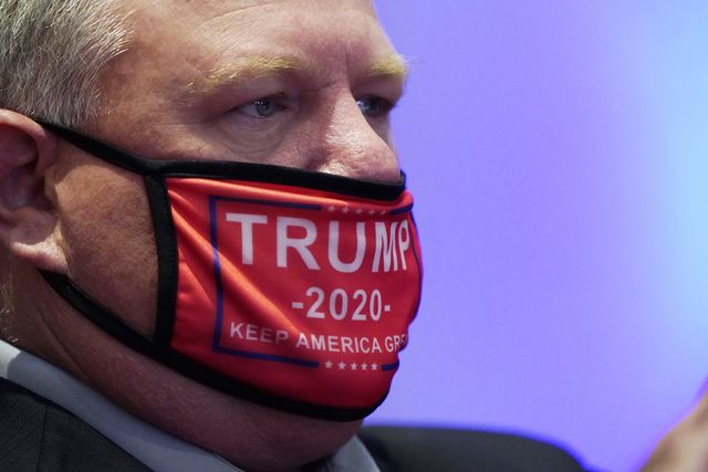 charlotte, north carolina   august 24 a delegate wearing a 'trump 2020' face mask arrives for the start of the first day of the republican national convention at the charlotte convention center on august 24, 2020 in charlotte, north carolina photo by chris carlson   poolgetty images
