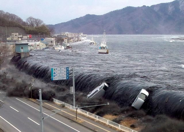 this picture taken by a miyako city official on march 11, 2011 and released on march 18, 2011 shows a tsunami breeching an embankment and flowing into the city of miyako in iwate prefecture shortly after a 90 magnitude earthquake hit the region of northern japan the official number of dead and missing after the devastating earthquake and tsunami that flattened japans northeast coast a week ago has topped 16,600, with 6,405 confirmed dead, it was announced on march 18, 2011    afp photo  jiji press photo by jiji press  jiji press  afp  japan out        photo credit should read jiji pressafp via getty images