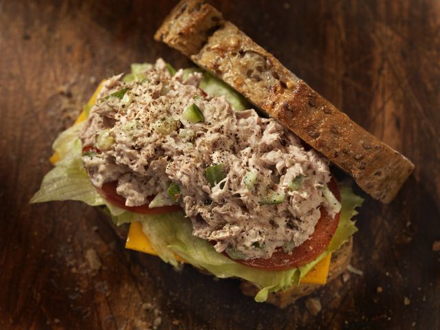 tuna salad sandwich with cheese, lettuce and tomatoes