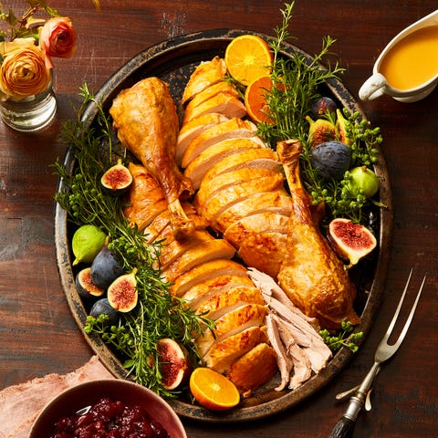 turkey cut into pieces on platter with cranberry sauce and gravy turkey cut into pieces on platter with cranberry sauce and gravy