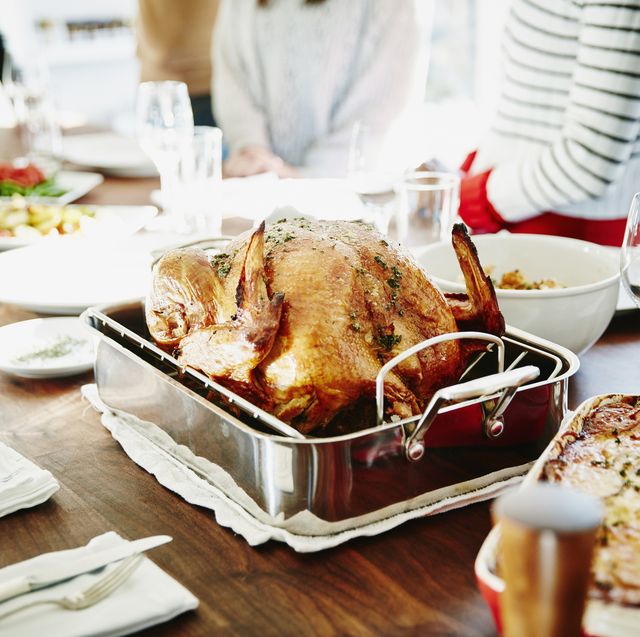turkey in roasting pan on table for holiday meal