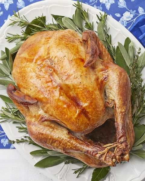 roasted thanksgiving turkey on platter with herbs