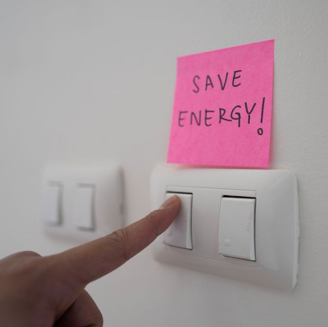 employee turn off a light switch for save energy in sustainable office