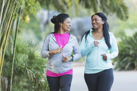Two African American women jogging together