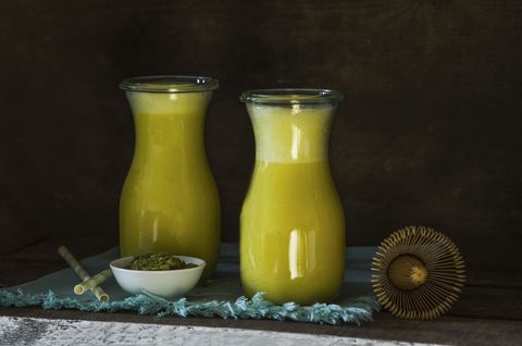Two glass bottles of matcha smoothie