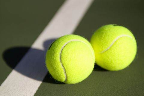 Two tennis balls on a tennis court