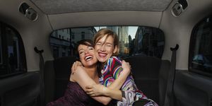 Two women in party dress in taxi