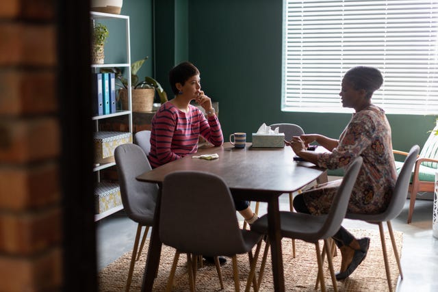 two women talking at counselling session in an office boardroom