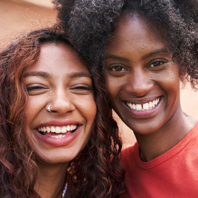 two young woman smiling to camera