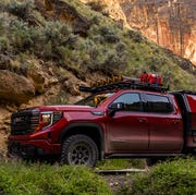 modified gmc sierra 1500 at4x pickup parked on a desert mountain trail