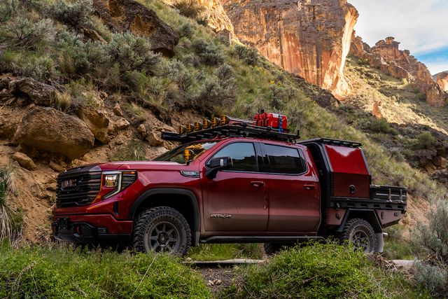 modified gmc sierra 1500 at4x pickup parked on a desert mountain trail