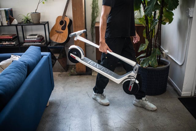 man holding unagi electric scooter
