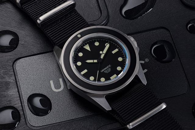 a black unimatic watch