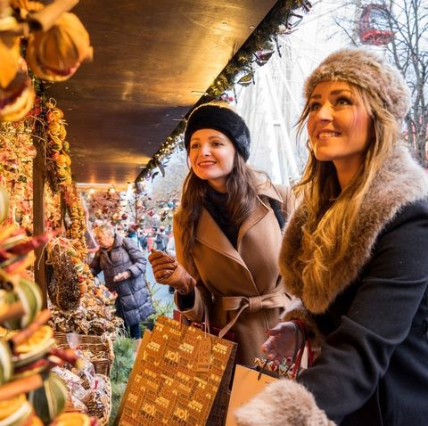 two women smiling at a stall for a Christmas market