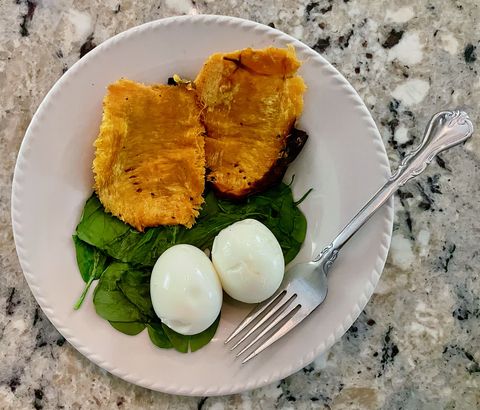two soft boiled large organic eggs and a roasted hannah sweet potato over spinach, one of my go to lunches