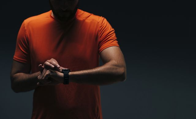 unrecognizable athlete using his smart watch to measure his pulse after workout