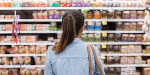 Unrecognizable woman marvels at grocery bread selection