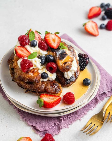 croissant french toast for two with berries on purple linen
